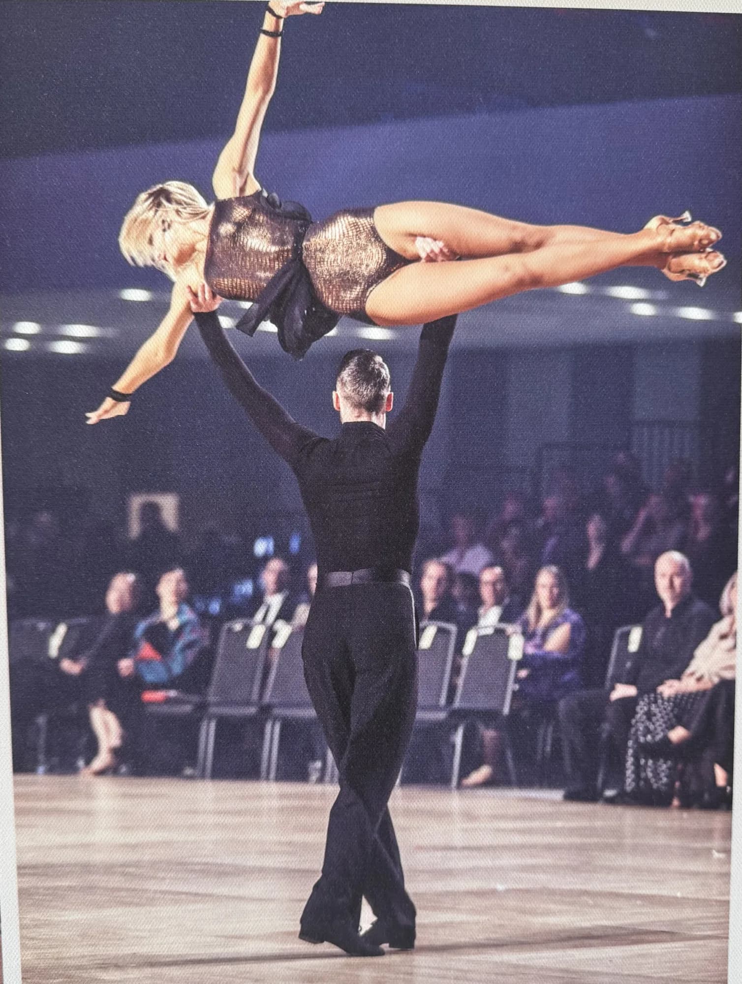 Jaimee falls into a deep backbend in an ice-blue gown as Travis guides the throw