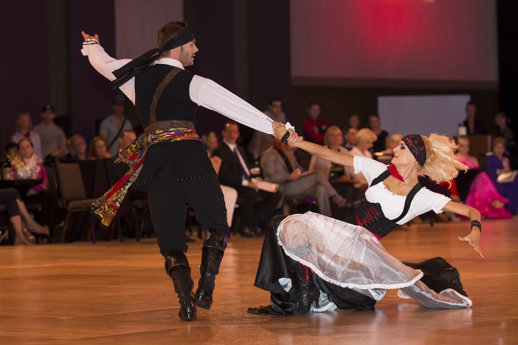 Travis and Jaimee in pirate costume finish a number low across the floor